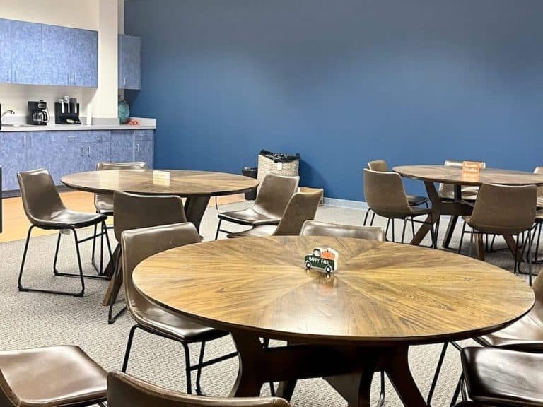 The Blueview break room, with round tables and chairs