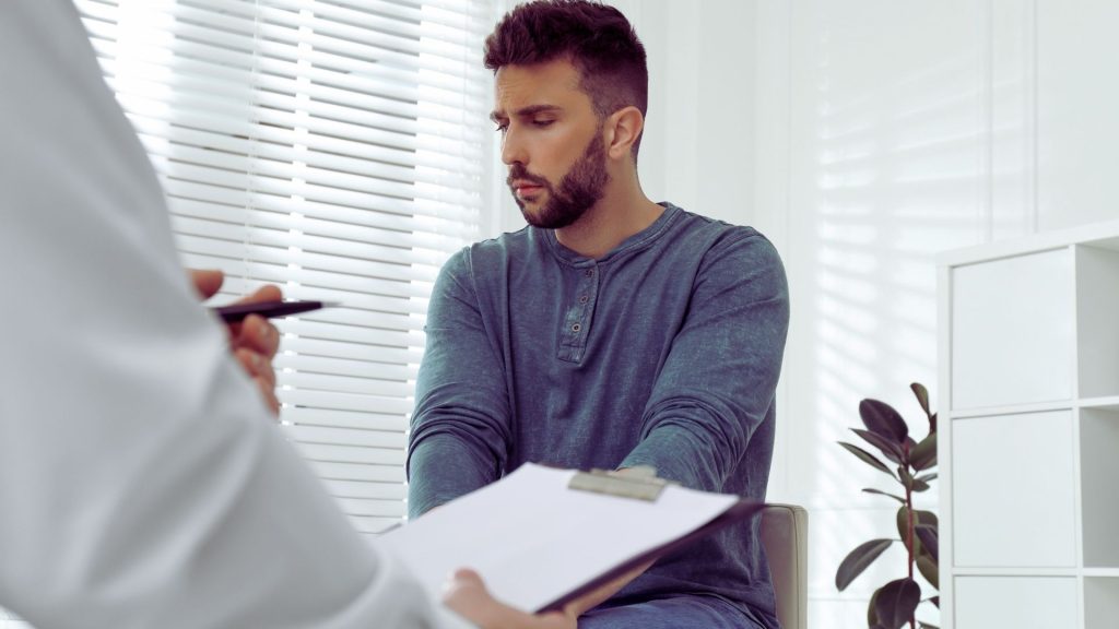 Person discussing cocaine addiction treatment with a healthcare professional