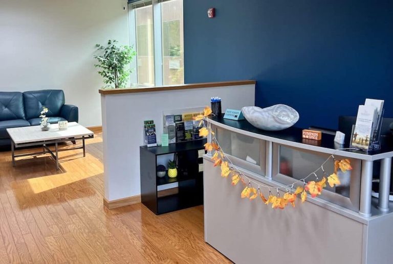 Blueview Recovery reception desk with brochures, fall decor, and waiting area seating nearby.