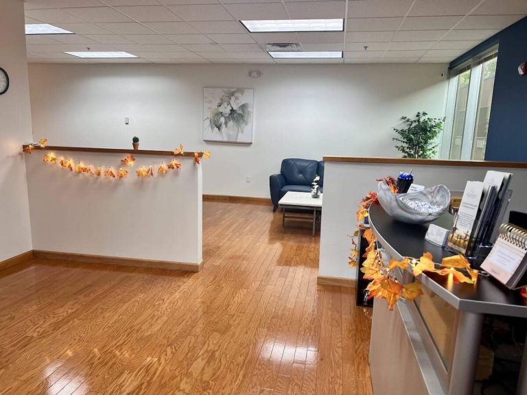 Blueview Recovery reception and waiting area with seating, brochures, and fall decorations.