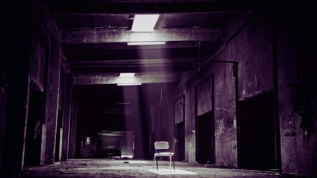Empty chair in a dim hallway symbolizing concern about cocaine use and its consequences