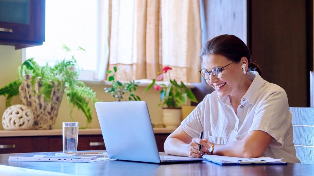 Person attending virtual IOP session from home workspace