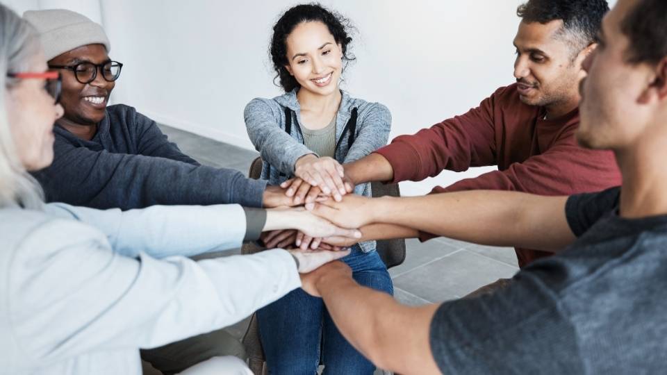 Who Pays for Sober Living Homes A group of people in sober living come together.