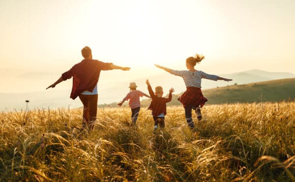 Happy family in nature at sunset