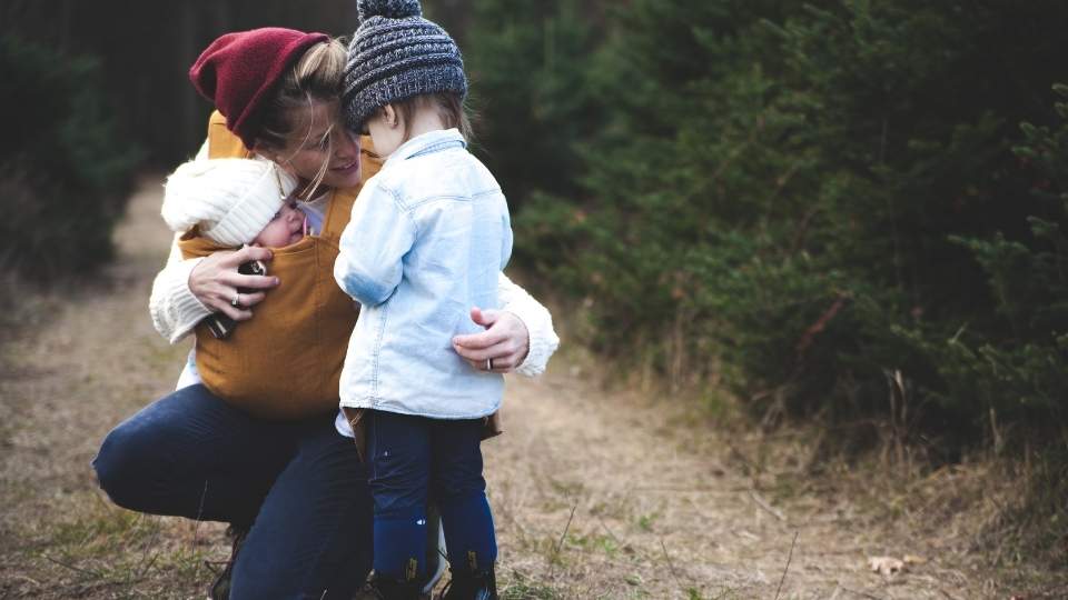 High-Functioning Anxiety hero image of a woman taking care of her children while struggling with anxiety.
