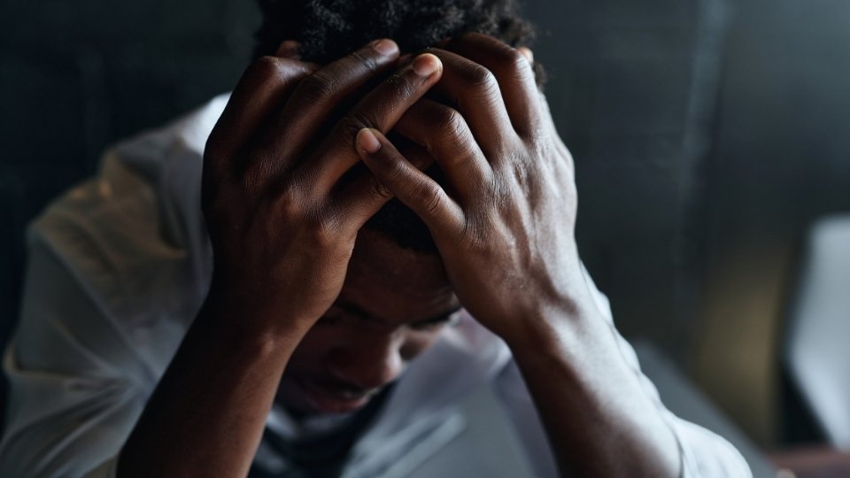 How to Stop Shaking from Anxiety Immediately? a man tries to contorl his breathing and ground his senses.
