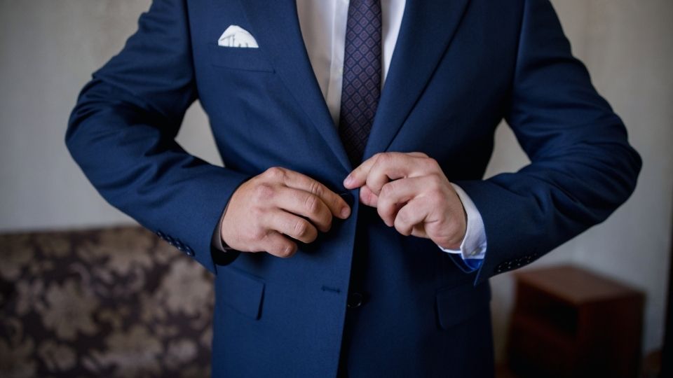 a man with functional depression puts on a suit with his face hidden.